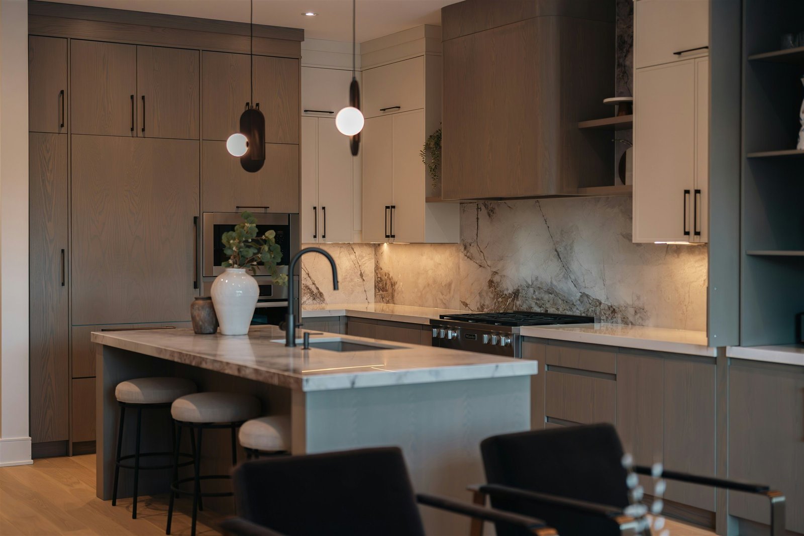 Full-height stone backsplash and countertop installation in a finished kitchen